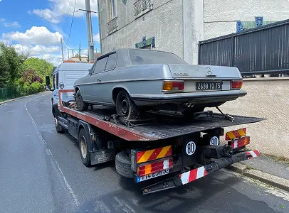 Une vieille Mercedes-Benz sur une dépanneuse dans une rue résidentielle à Nanterre en Hauts-de-Seine 92